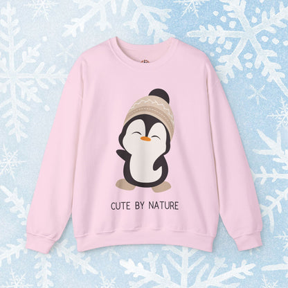 Cute Penguin Sweatshirt - Unisex Heavy Blend™ Crewneck, Cute by Nature, big cute winter penguin design, underneath a text "cute by nature"