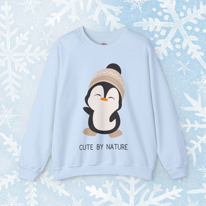 Cute Penguin Sweatshirt - Unisex Heavy Blend™ Crewneck, Cute by Nature, big cute winter penguin design, underneath a text "cute by nature"