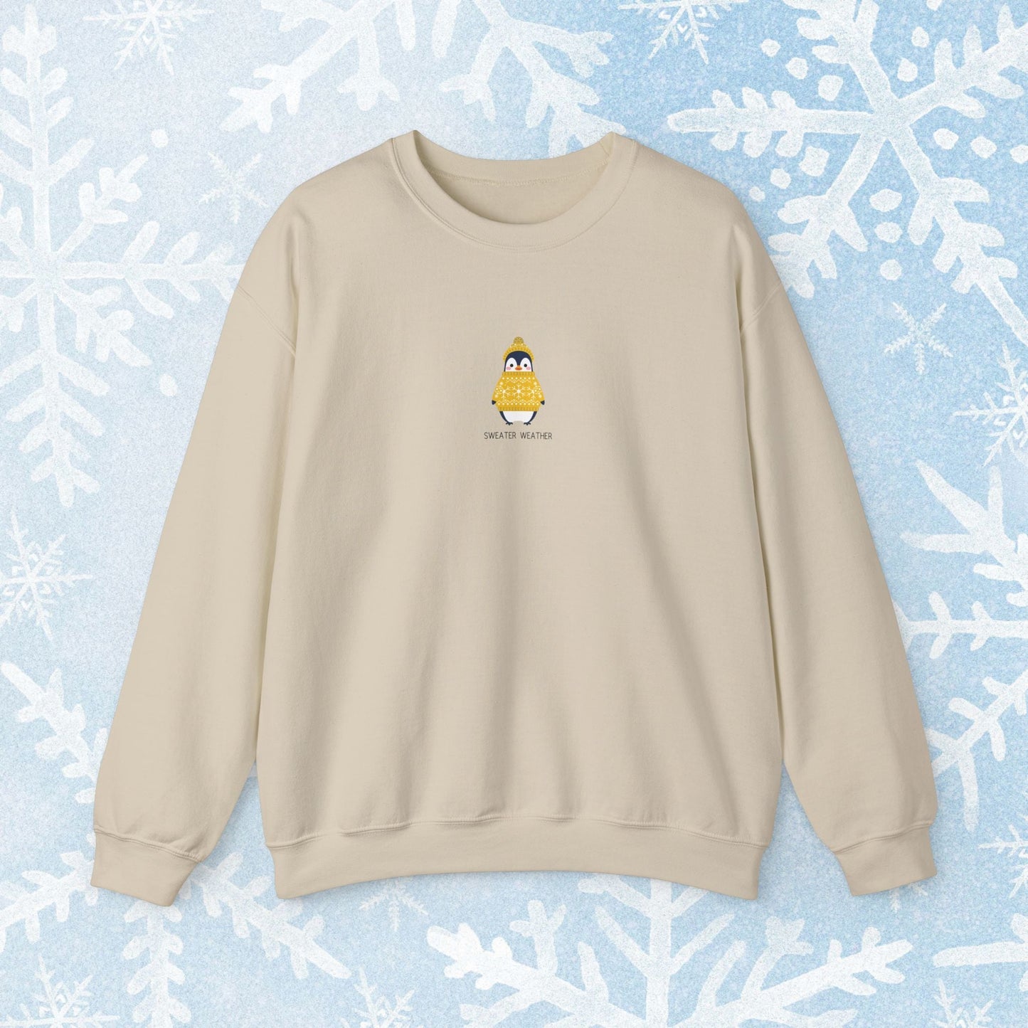 Sweater Weather Unisex Crewneck Sweatshirt - Staying Warm and Fuzzy. Small centered Penguin design wearing a yellow Sweater with text under "sweater weater"