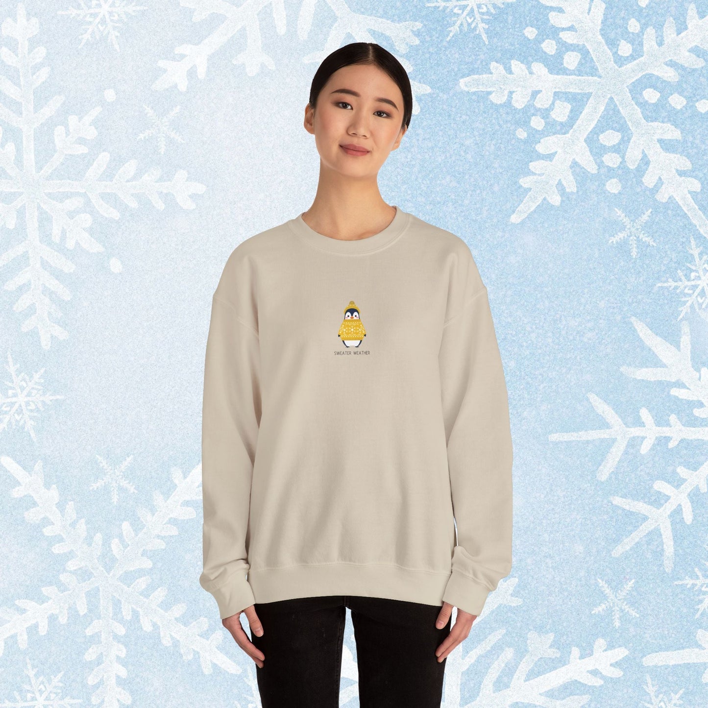 Sweater Weather Unisex Crewneck Sweatshirt - Staying Warm and Fuzzy. Small centered Penguin design wearing a yellow Sweater with text under "sweater weater"