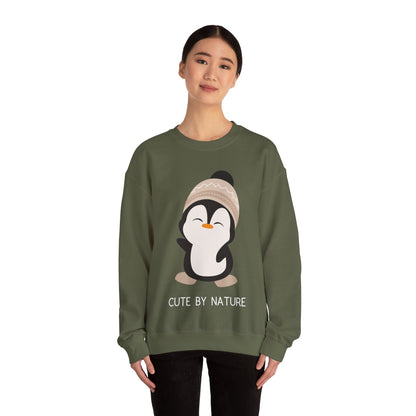 Cute Penguin Sweatshirt - Unisex Heavy Blend™ Crewneck, Cute by Nature, big cute winter penguin design, underneath a text "cute by nature"