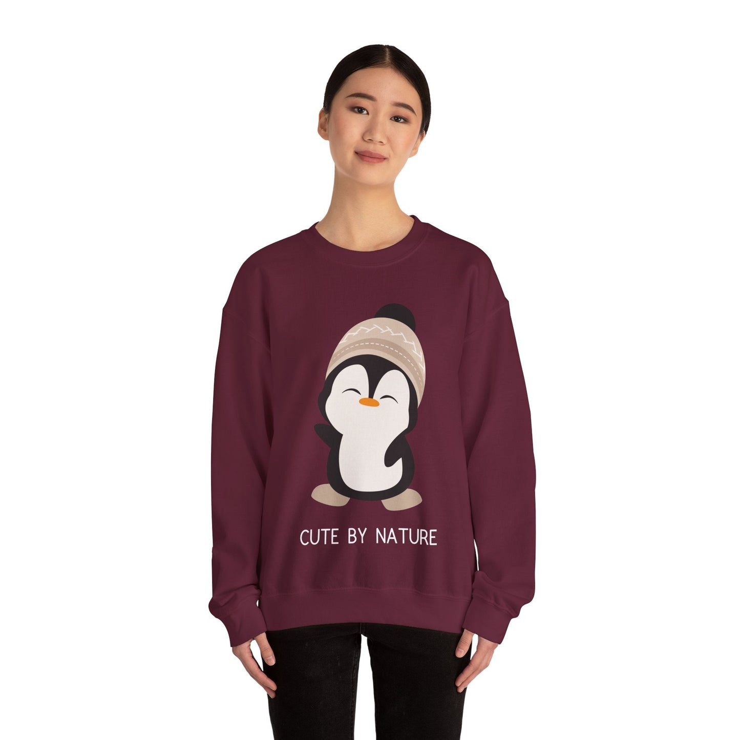 Cute Penguin Sweatshirt - Unisex Heavy Blend™ Crewneck, Cute by Nature, big cute winter penguin design, underneath a text "cute by nature"