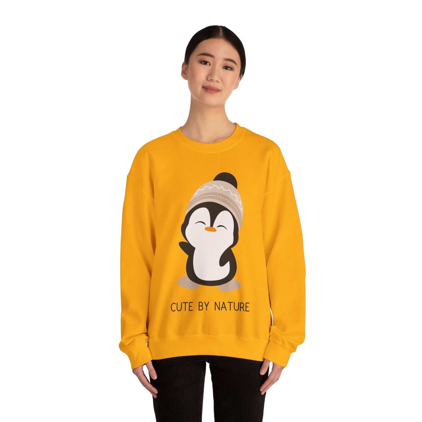 Cute Penguin Sweatshirt - Unisex Heavy Blend™ Crewneck, Cute by Nature, big cute winter penguin design, underneath a text "cute by nature"