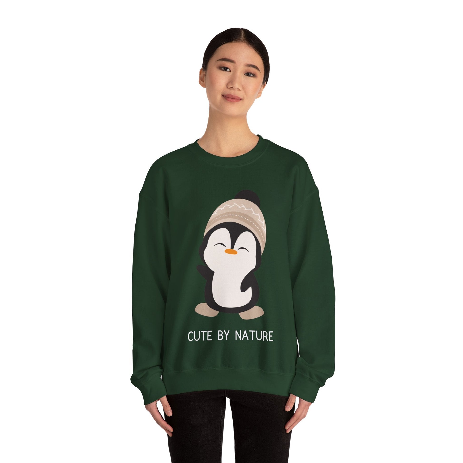 Cute Penguin Sweatshirt - Unisex Heavy Blend™ Crewneck, Cute by Nature, big cute winter penguin design, underneath a text "cute by nature"