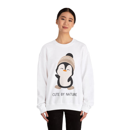 Cute Penguin Sweatshirt - Unisex Heavy Blend™ Crewneck, Cute by Nature, big cute winter penguin design, underneath a text "cute by nature"