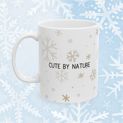 Penguin Mug - Cute Ceramic white mug with a cute penguin design wearing a winter hat. On the other side of the mug there is a text saying "Cute by nature".