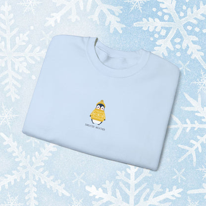 Sweater Weather Unisex Crewneck Sweatshirt - Staying Warm and Fuzzy. Small centered Penguin design wearing a yellow Sweater with text under "sweater weater"