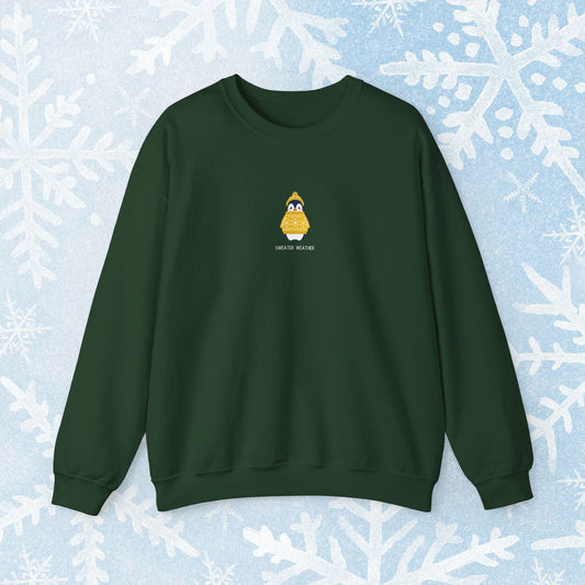 Sweater Weather Unisex Crewneck Sweatshirt - Staying Warm and Fuzzy. Small centered Penguin design wearing a yellow Sweater with text under "sweater weater"