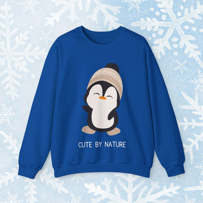 Cute Penguin Sweatshirt - Unisex Heavy Blend™ Crewneck, Cute by Nature, big cute winter penguin design, underneath a text "cute by nature"