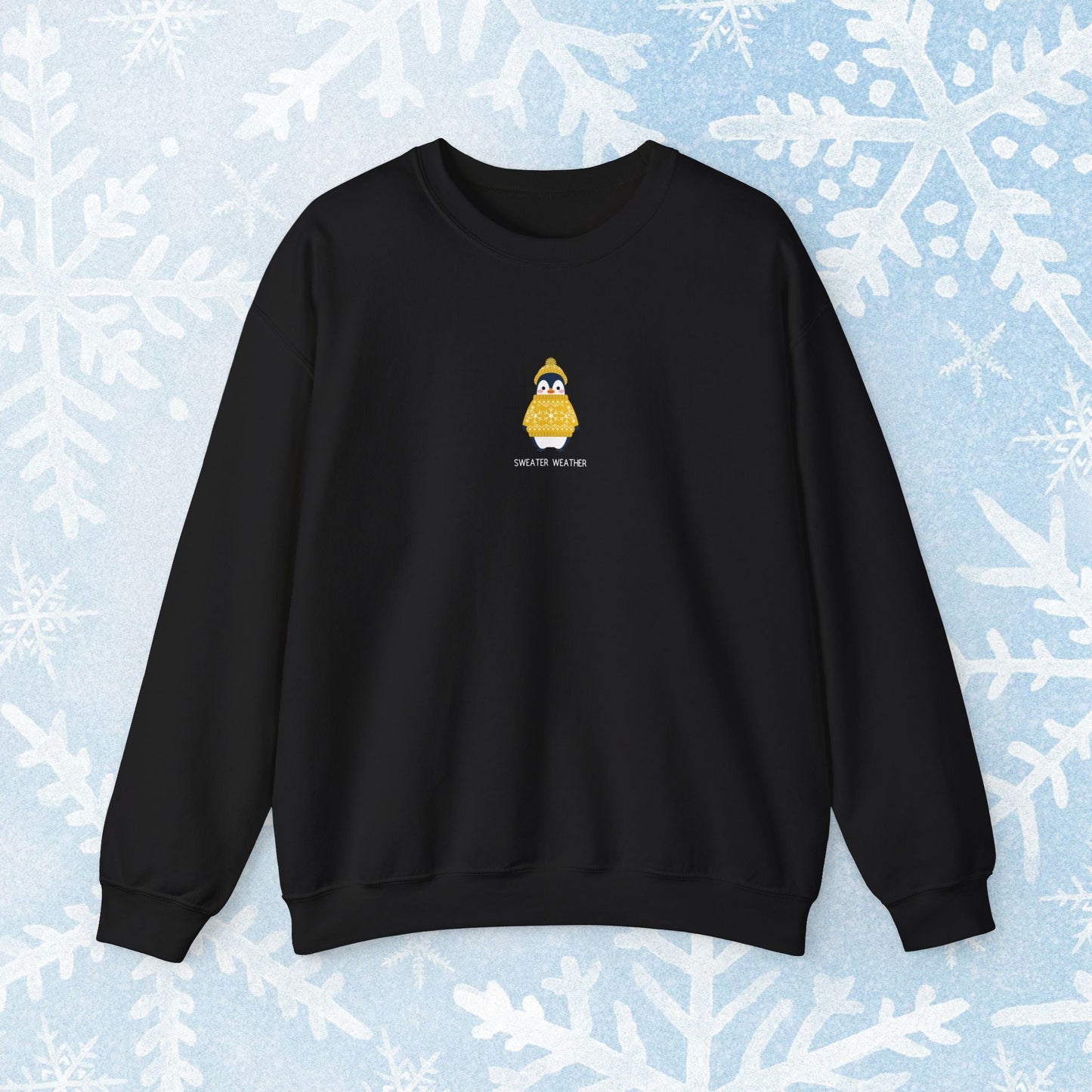 Sweater Weather Unisex Crewneck Sweatshirt - Staying Warm and Fuzzy. Small centered Penguin design wearing a yellow Sweater with text under "sweater weater"